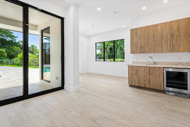 3100 Palm Dr, Delray Beach, FL 33483 - bar with indoor wet bar, light wood-style floors, wine cooler, and a sink