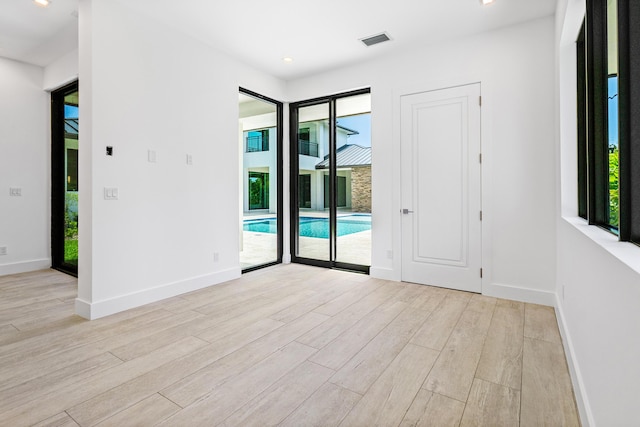 3100 Palm Dr, Delray Beach, FL 33483 - spare room with light wood-style floors, visible vents, and a wealth of natural light
