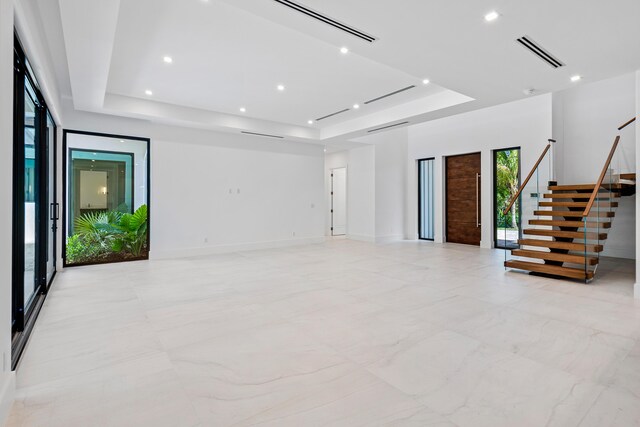 3100 Palm Dr, Delray Beach, FL 33483 - spare room featuring stairs, a tray ceiling, and visible vents