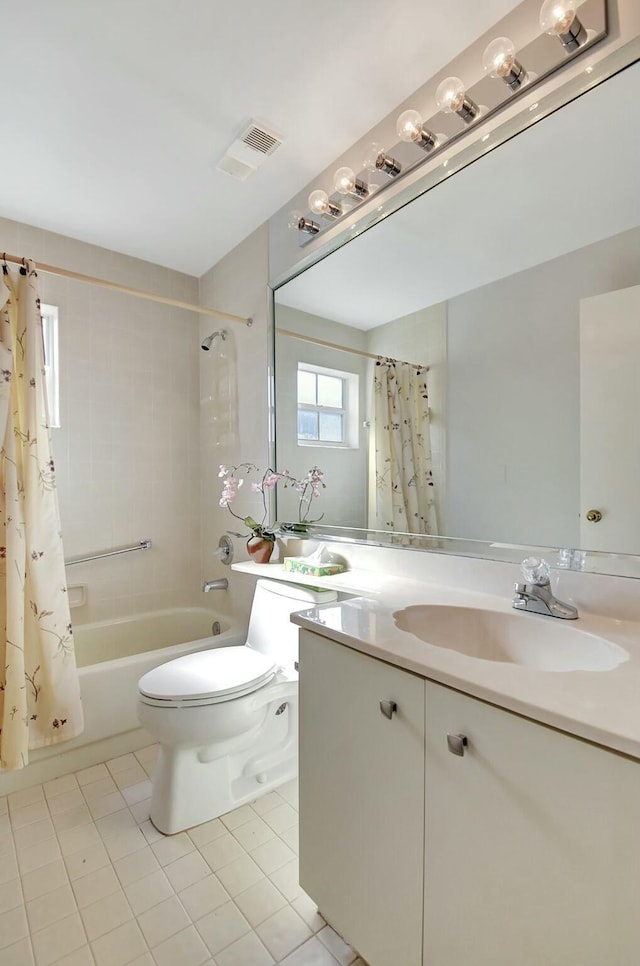 full bathroom featuring toilet, vanity, tile patterned floors, and shower / bath combination with curtain