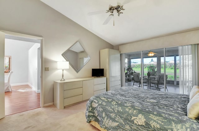 bedroom with ceiling fan, multiple windows, access to outside, and vaulted ceiling