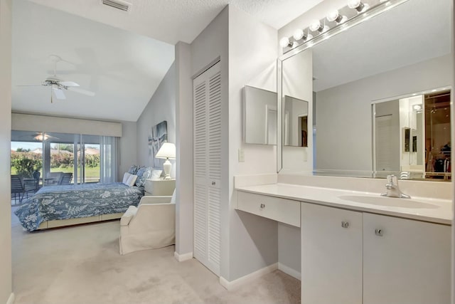 bathroom featuring vaulted ceiling, ceiling fan, and vanity