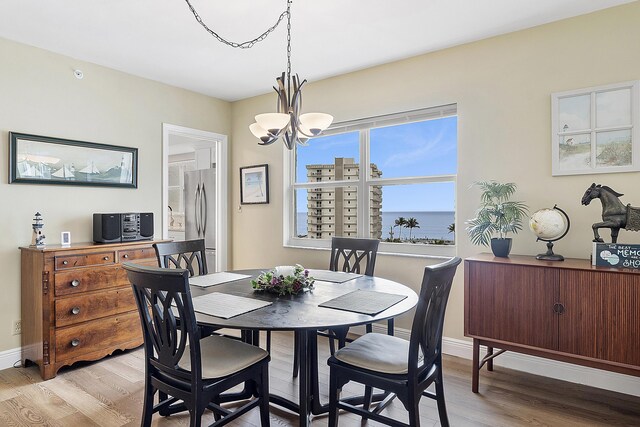 kitchen featuring appliances with stainless steel finishes, light stone counters, white cabinets, backsplash, and sink