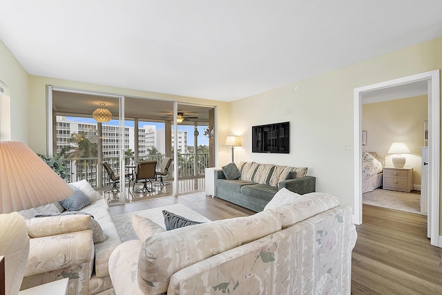 living room with hardwood / wood-style floors and ceiling fan