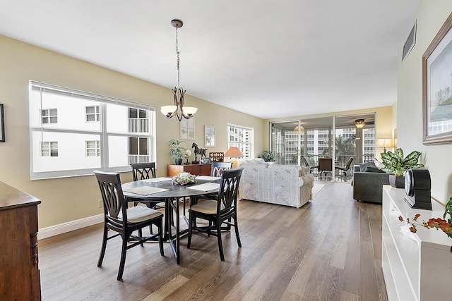 dining room with hardwood / wood-style flooring and a chandelier