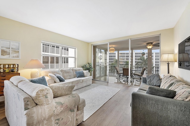 living room with ceiling fan and wood-type flooring