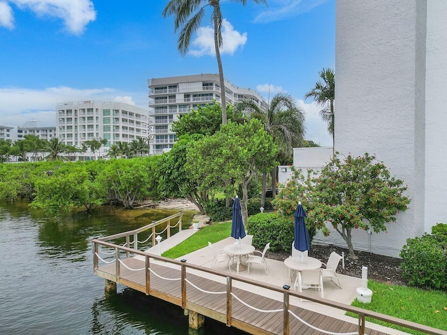 surrounding community featuring a water view and a patio