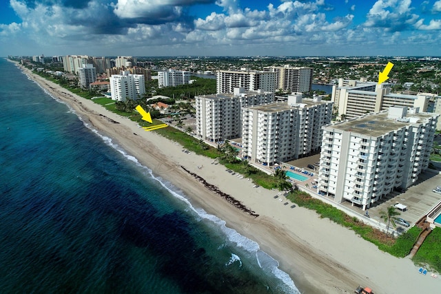 drone / aerial view featuring a water view and a beach view