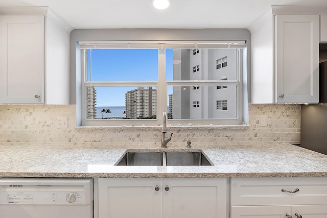 kitchen featuring white cabinetry, dishwasher, and sink