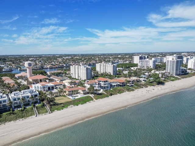 bird's eye view featuring a water view and a beach view