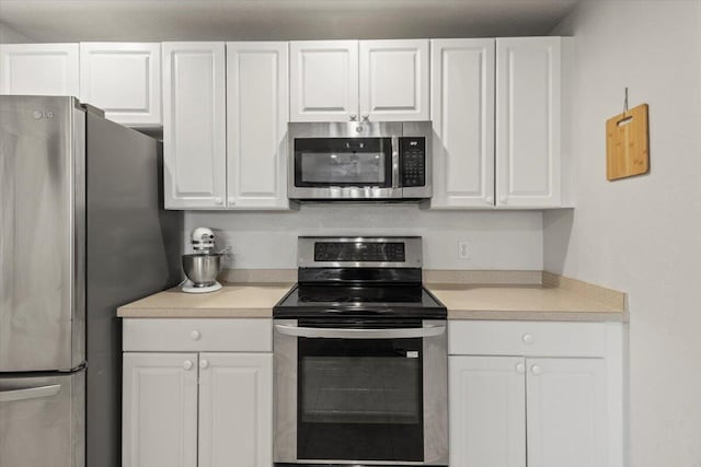 kitchen featuring appliances with stainless steel finishes and white cabinetry