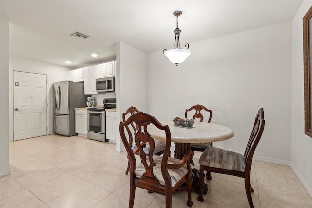 dining area with light tile patterned floors