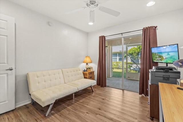 living area featuring ceiling fan and light hardwood / wood-style floors