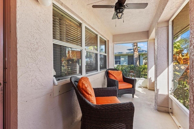 sunroom featuring ceiling fan and a wealth of natural light