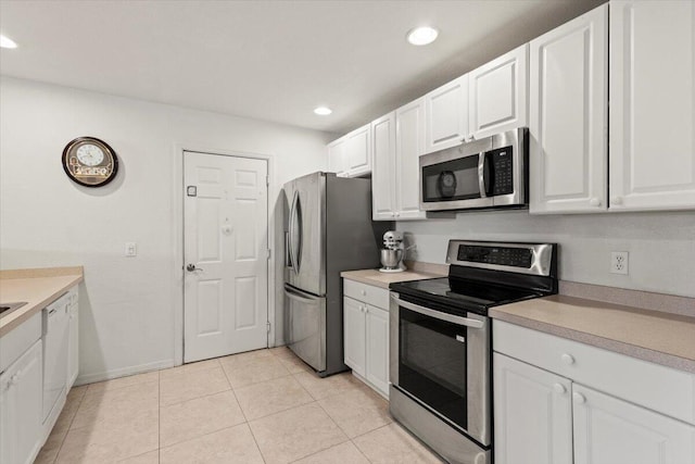 kitchen with stainless steel appliances, recessed lighting, light countertops, and white cabinets