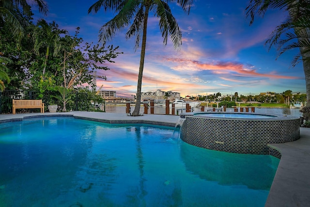 pool at dusk with a water view