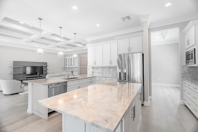 kitchen with a spacious island, white cabinets, beam ceiling, and coffered ceiling