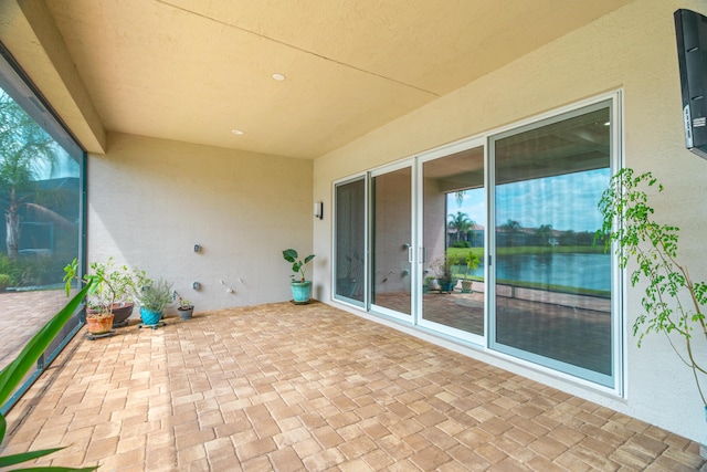 view of patio with a water view