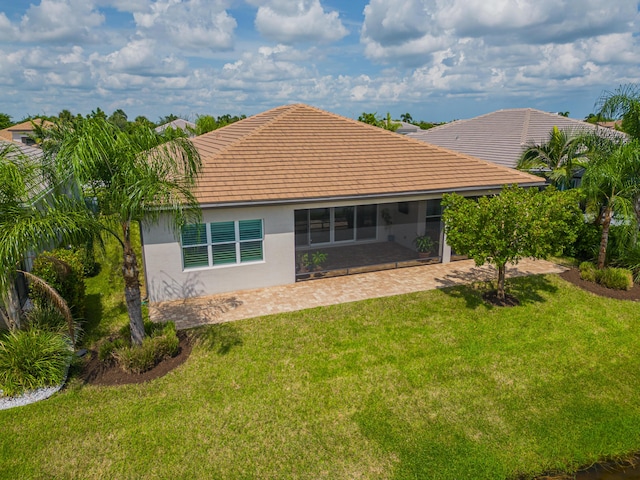 rear view of property with a lawn