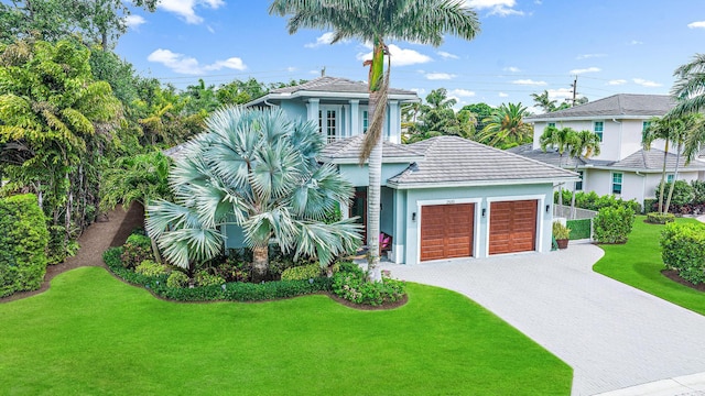 view of front facade with a front yard and a garage