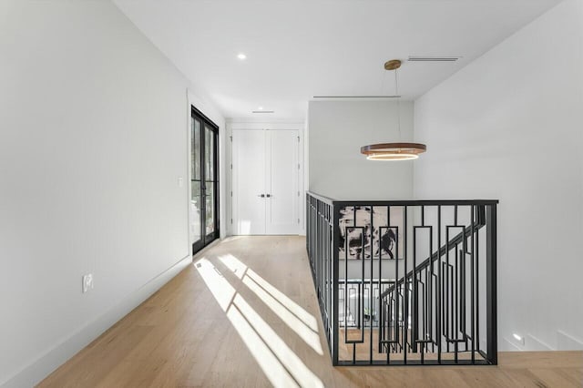 corridor with french doors and hardwood / wood-style flooring