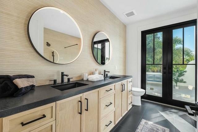 bathroom with decorative backsplash, vanity, and toilet