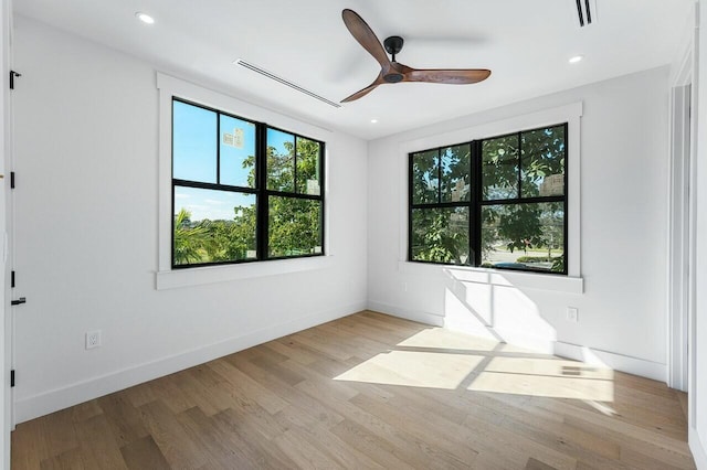 empty room featuring ceiling fan and light hardwood / wood-style flooring