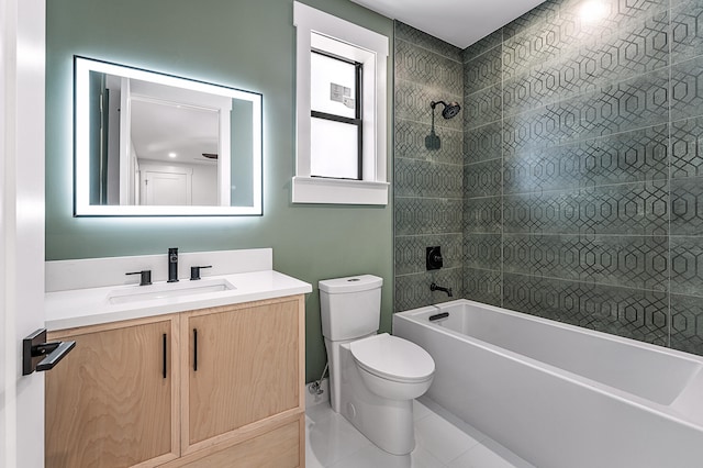 full bathroom with tile patterned flooring, tiled shower / bath combo, vanity, and toilet