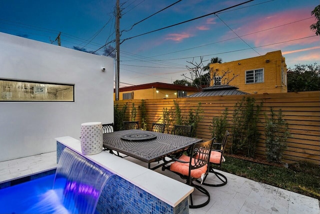 patio terrace at dusk with pool water feature