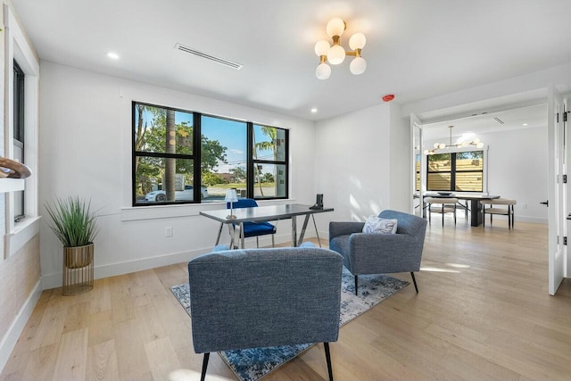 sitting room featuring a notable chandelier and light hardwood / wood-style floors