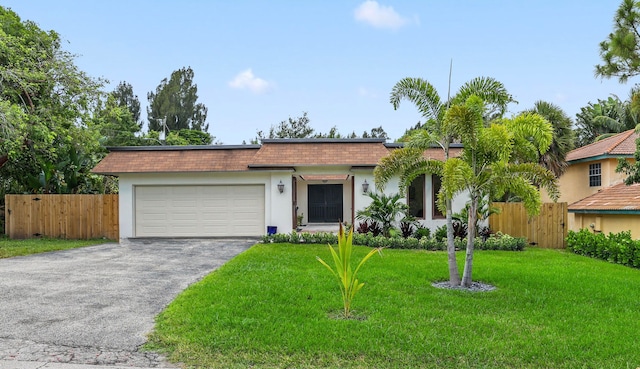 single story home with a front yard and a garage