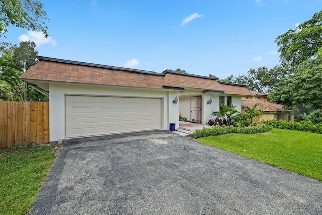 ranch-style home with a front yard and a garage