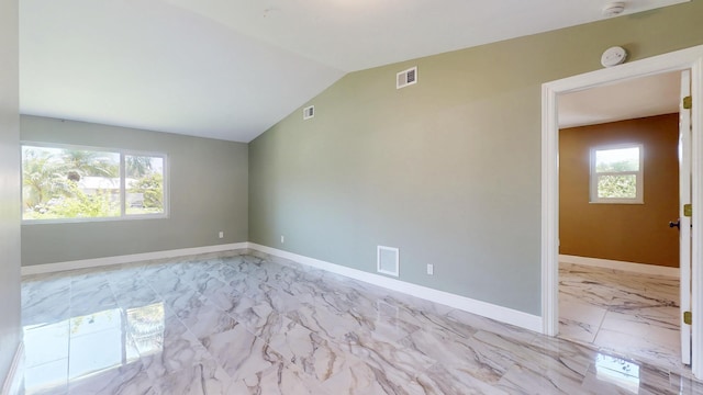 601 SE Karrigan Ter, Port Saint Lucie, FL 34983 - unfurnished room featuring a smoke detector, light marble finish flooring, and vaulted ceiling