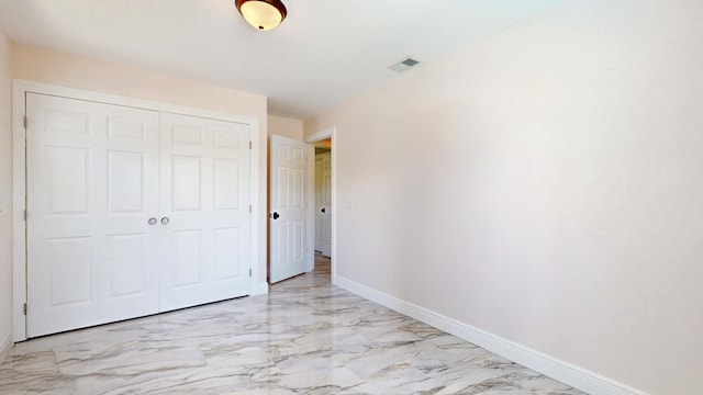 601 SE Karrigan Ter, Port Saint Lucie, FL 34983 - unfurnished bedroom featuring light marble finish floors and a closet