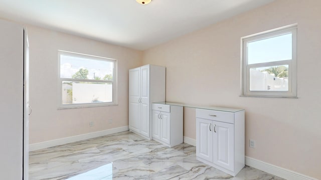 601 SE Karrigan Ter, Port Saint Lucie, FL 34983 - unfurnished bedroom with light marble finish floors and baseboards