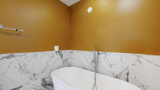 601 SE Karrigan Ter, Port Saint Lucie, FL 34983 - full bathroom featuring a soaking tub and marble finish flooring