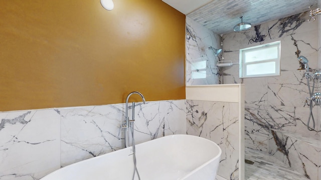 601 SE Karrigan Ter, Port Saint Lucie, FL 34983 - bathroom with tile walls, a marble finish shower, and a soaking tub
