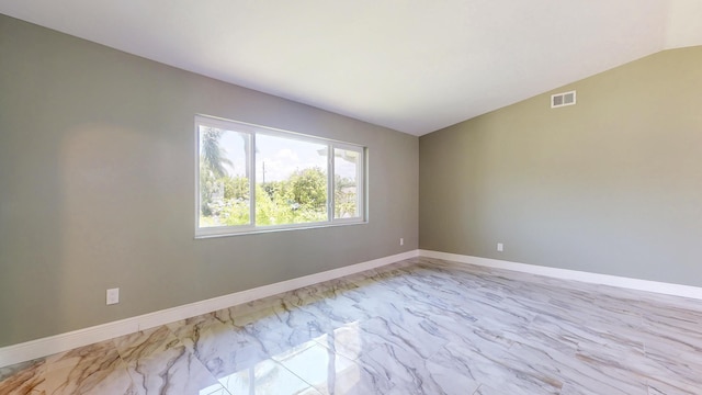 601 SE Karrigan Ter, Port Saint Lucie, FL 34983 - unfurnished room featuring marble finish floors and vaulted ceiling