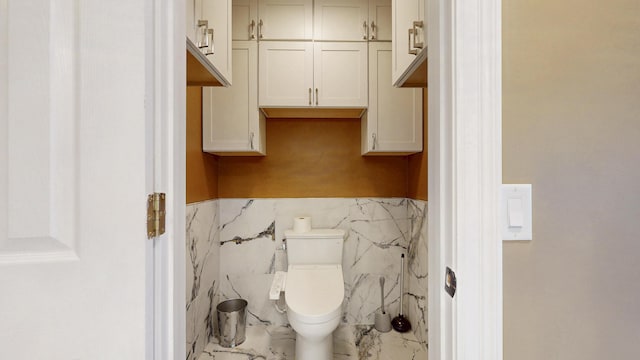 601 SE Karrigan Ter, Port Saint Lucie, FL 34983 - half bath with a wainscoted wall, tile walls, and marble finish floors
