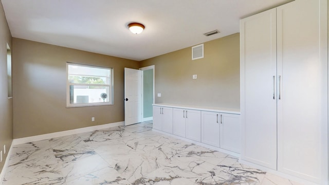 601 SE Karrigan Ter, Port Saint Lucie, FL 34983 - spare room featuring light marble finish floors and baseboards