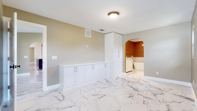 601 SE Karrigan Ter, Port Saint Lucie, FL 34983 - empty room with light marble finish flooring and arched walkways