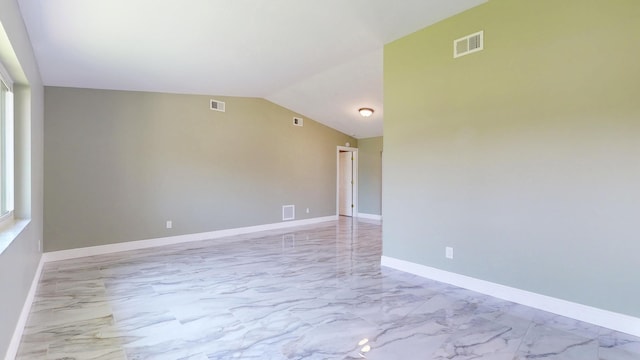 601 SE Karrigan Ter, Port Saint Lucie, FL 34983 - spare room featuring marble look tiles and lofted ceiling