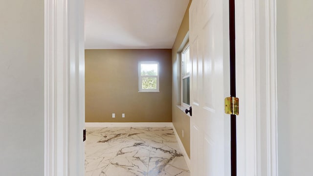 601 SE Karrigan Ter, Port Saint Lucie, FL 34983 - corridor featuring marble tiled floors and baseboards