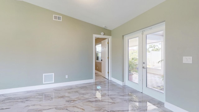 601 SE Karrigan Ter, Port Saint Lucie, FL 34983 - empty room with french doors, lofted ceiling, and light marble finish floors