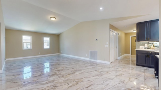 601 SE Karrigan Ter, Port Saint Lucie, FL 34983 - unfurnished living room featuring light marble finish flooring, vaulted ceiling, and recessed lighting