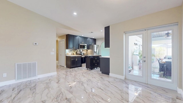 601 SE Karrigan Ter, Port Saint Lucie, FL 34983 - kitchen with appliances with stainless steel finishes, light countertops, french doors, light marble finish floors, and recessed lighting