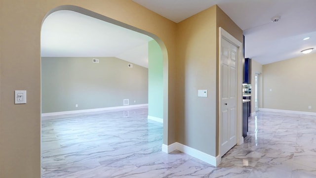 601 SE Karrigan Ter, Port Saint Lucie, FL 34983 - corridor featuring light marble finish floors, arched walkways, and lofted ceiling