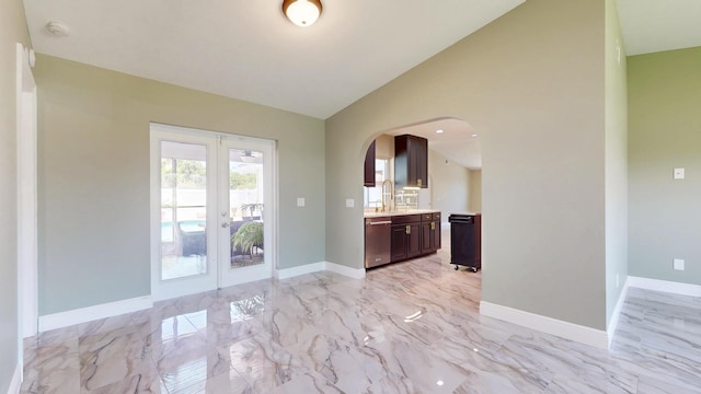 601 SE Karrigan Ter, Port Saint Lucie, FL 34983 - kitchen featuring dishwasher, light countertops, french doors, arched walkways, and dark brown cabinetry