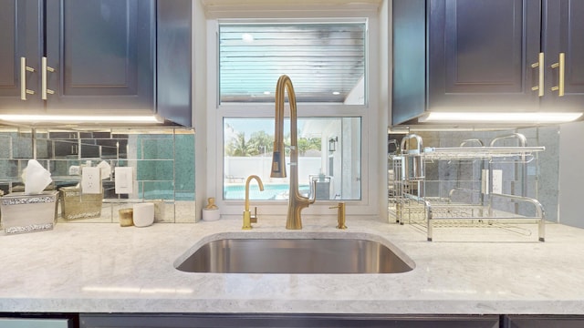 601 SE Karrigan Ter, Port Saint Lucie, FL 34983 - kitchen with tasteful backsplash and light stone counters