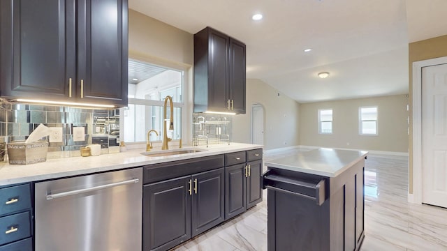 601 SE Karrigan Ter, Port Saint Lucie, FL 34983 - kitchen featuring dishwasher, decorative backsplash, vaulted ceiling, a kitchen island, and light marble finish floors